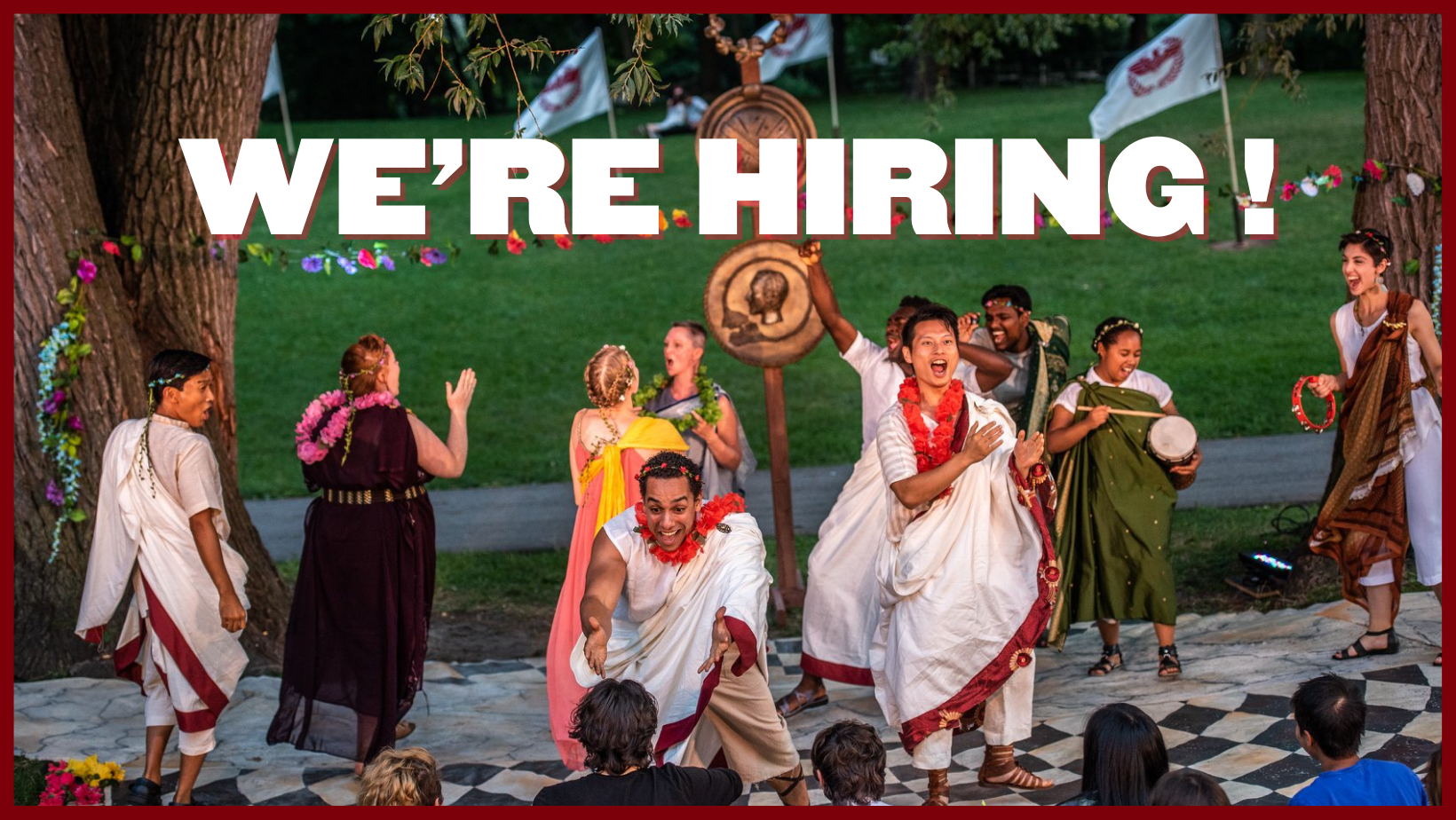 We're Hiring! in bold letter across the top. An image of a group of cheering actors in roman togas